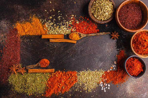 Different kind of spices on dark background. Food frame, top view, copy space. - Foto, imagen