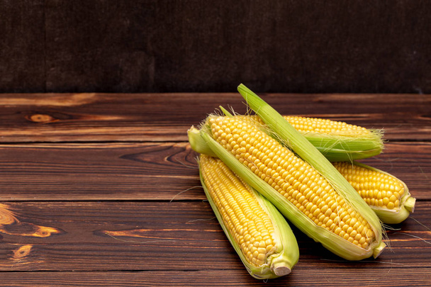 Corn cobs on wooden table.  - Fotografie, Obrázek
