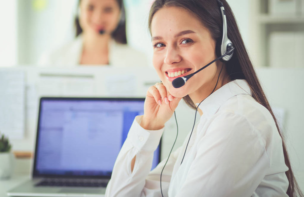 Smiling businesswoman or helpline operator with headset and computer at office - Valokuva, kuva