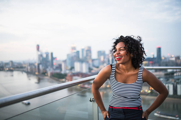 A portrait of businesswoman standing against London rooftop view panorama. - Photo, Image