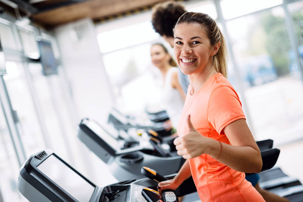 Picture of people doing cardio training on treadmill in gym - Fotografie, Obrázek