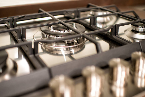 Modern gas burner and hob on a kitchen range in a close in cropped view of the appliance - Foto, immagini
