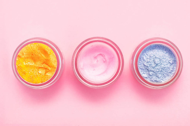 Jars of body cream on color background. Cope space, flat lay, top view. - Photo, Image