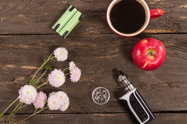 Still life with vape devices and coffee on the wooden background. - Photo, Image