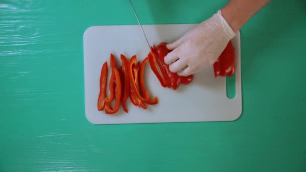 male chef is using sharp knife to cut bell pepper - Footage, Video
