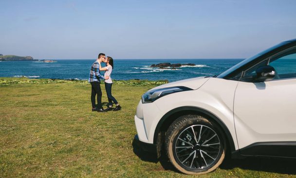 Couple with car watching landscape - Photo, Image