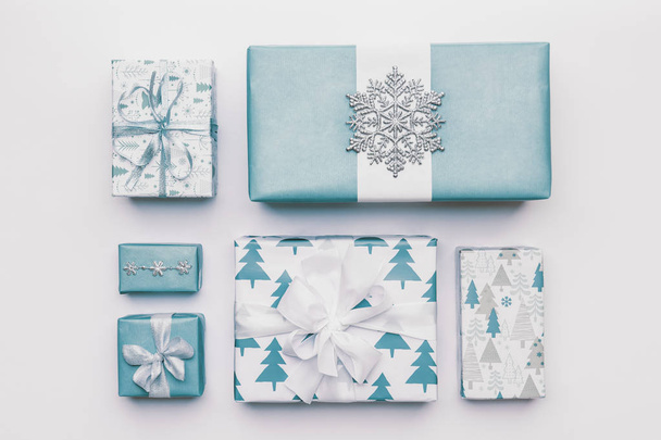 Beautiful nordic christmas gifts isolated on white background. Pastel blue colored wrapped xmas boxes. Gift wrapping concept. - Foto, imagen
