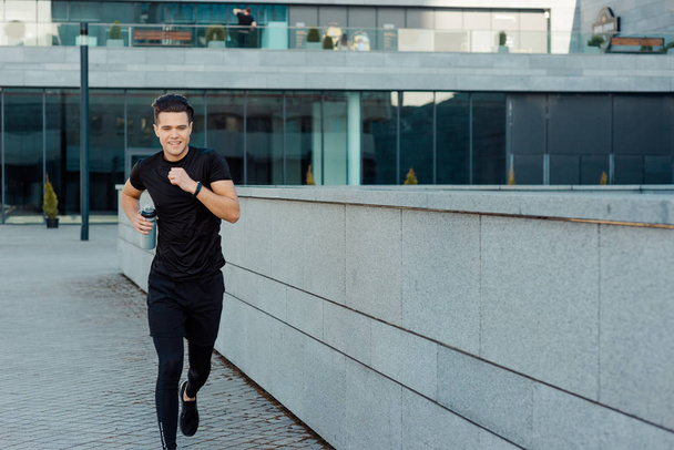 Active man jogging in city - Photo, image
