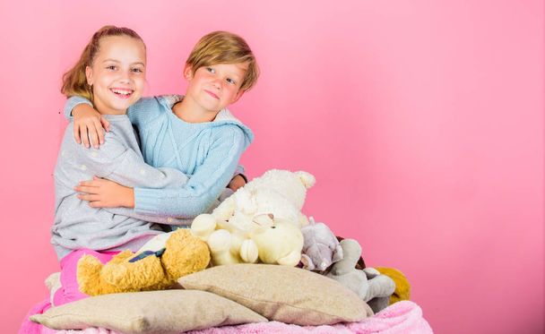 Children friends near teddy bear soft toys cuddling. Girl and boy friends cheerful mood hug each other. Friendship concept. Best friends brother and sister. Kids siblings friends hug pink background - Foto, Imagen