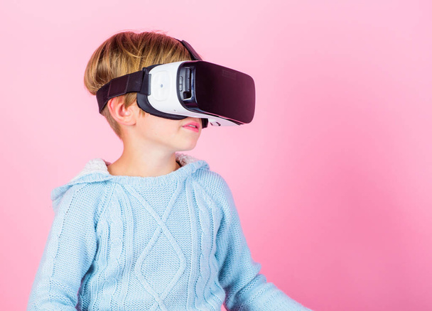 Kid boy wear vr glasses pink background. Child boy play virtual reality game. Explore alternative reality. Cyber space and virtual gaming. Virtual reality future technology. Discover virtual reality - Foto, Imagen