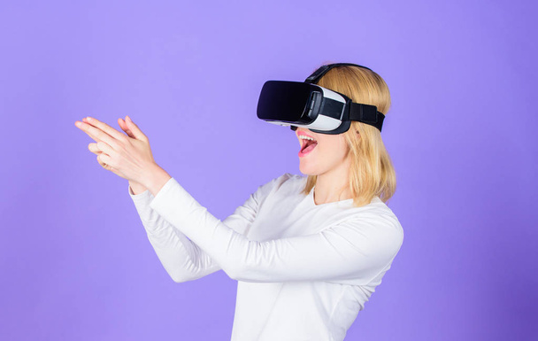 Woman head mounted display violet background. Virtual reality shooting gallery. Girl use modern technology vr headset play shooter game. Lady with gun gesture. Enthralling interaction virtual reality - Foto, Imagem