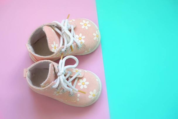 Baby pink shoes on a bright background - Фото, зображення