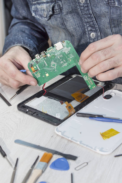 Tablet repair. Removing the matrix and integrated circuit from the tablet. - Fotó, kép