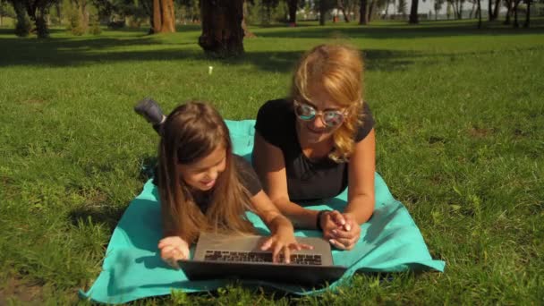 mother using laptop with her daughter - Video