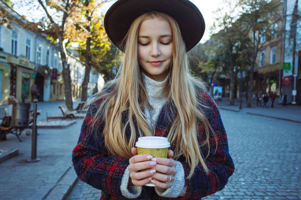 Woman holding cup of hot drink - 写真・画像