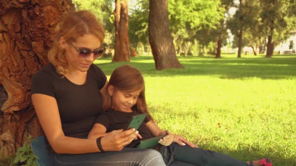 happy family enjoying time in the park - Filmati, video