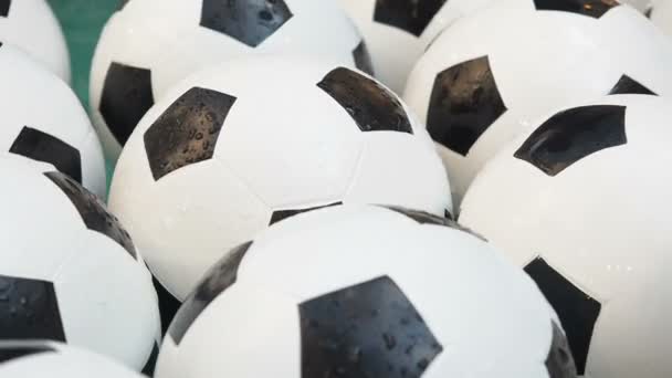 Many Black and White Soccer Balls Background. Football Balls Swimming in a Pure Water Close Up - Filmagem, Vídeo