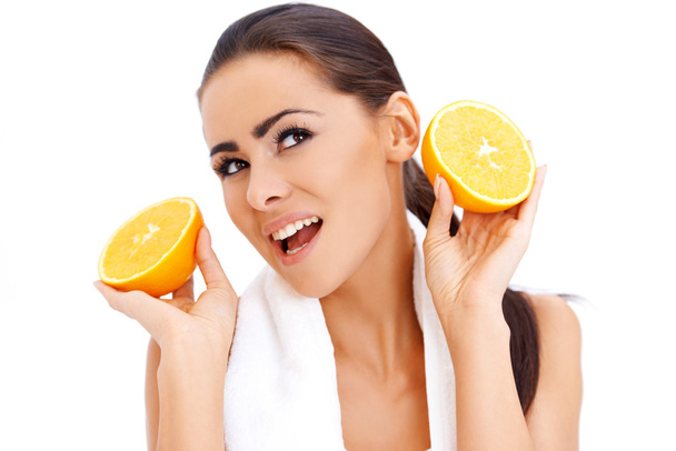 Woman with fresh orange halfs in her hands - Zdjęcie, obraz