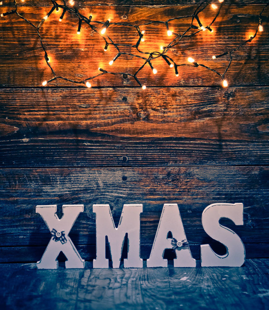 christmas decorations and lights on wooden background - Valokuva, kuva