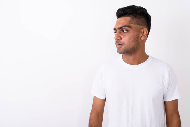 Young Indian man wearing white shirt against white background  - Photo, Image