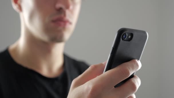 Closeup of Young Man Using Smartphone, Browsing in Internet or Checking Social Networks - Footage, Video