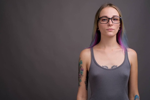 Young beautiful rebellious woman with multicolored hair against  - Photo, image