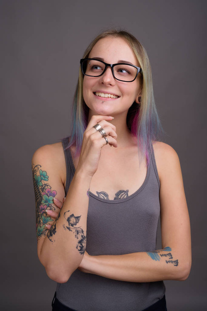 Young beautiful rebellious woman with multicolored hair against  - Photo, Image