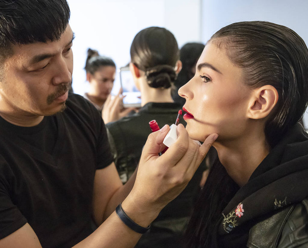 New York, NY - September 11, 2018: A model prepares backstage for the Naeem Khan Spring Summer 2019 fashion show during New York Fashion Week Women's - Photo, Image