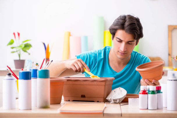 Young man decorating pottery in class - Photo, Image