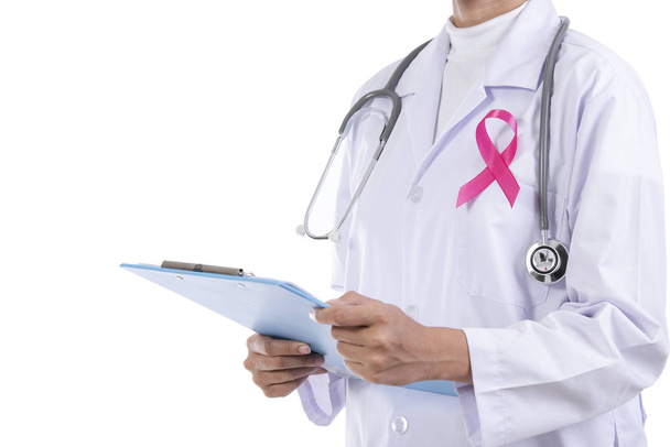 Doctor woman with pink ribbon on her chest, supporting symbol of breast cancer awareness and international women day campaign. - Photo, Image