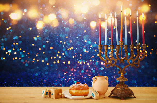 image of jewish holiday Hanukkah background with menorah (traditional candelabra) and candles over glitter shiny background - Φωτογραφία, εικόνα