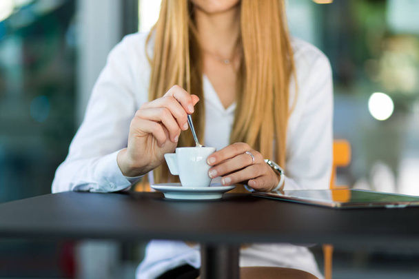 Mid section of woman having a coffee in a cafe - Photo, image