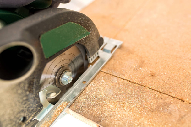 Wood cutting with circular saw zoomed in for closeup shot - 写真・画像