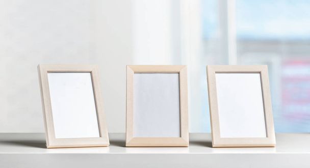 empty picture frames on the table   - Фото, зображення