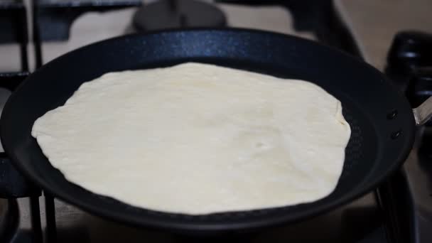 Λευκό τορτίγια μαγειρεμένα και γυρνάει σε καυτό τηγάνι τηγάνι. - Πλάνα, βίντεο