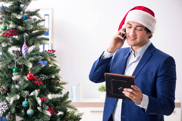 Jeune employé célébrant Noël sur le lieu de travail
 - Photo, image