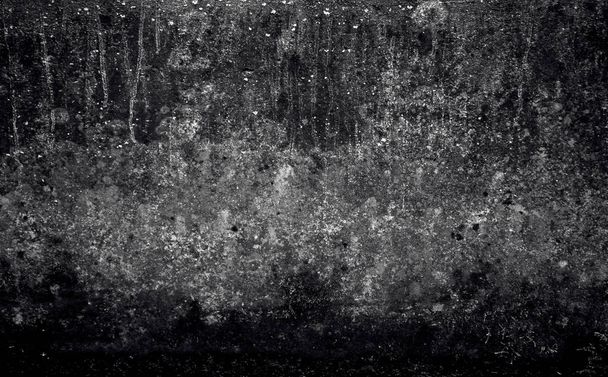 piece of a wall of black and gray shades, on the surface from the top, thin strains stretch downward, throughout the texture there are small and large spot,  old texture, shabby appearance,   - Photo, Image