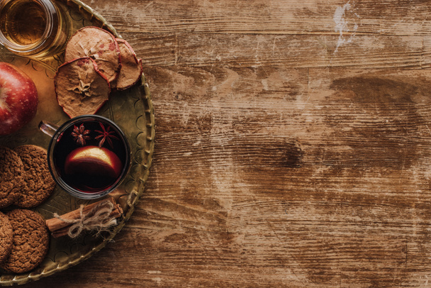 elevated view of mulled wine in cup and cookies on wooden tabletop, christmas concept - Zdjęcie, obraz