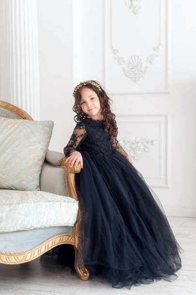Portrait of cute smiling little girl in black princess fluffy dress. - Photo, Image