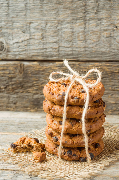 Homemade cookies with chocolate thread tied on a wooden table. - Fotografie, Obrázek