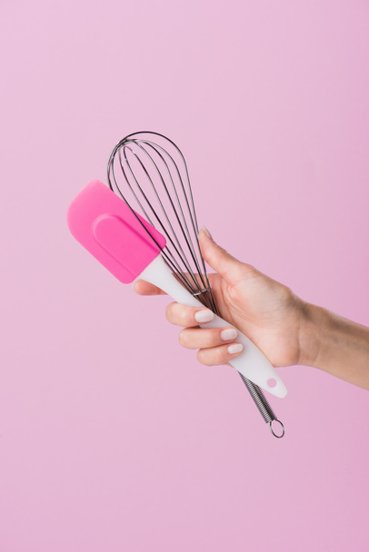 cropped shot of woman holding spatula and whisk isolated on pink - Fotoğraf, Görsel