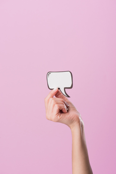 cropped shot of woman holding blank speech bubble isolated on pink - Photo, Image