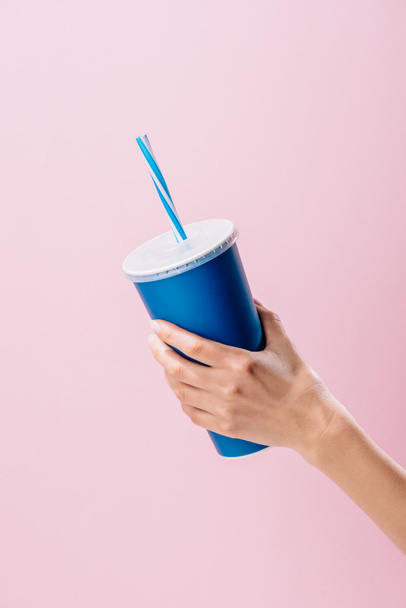 cropped shot of woman holding paper cup with drink isolated on pink - Фото, изображение