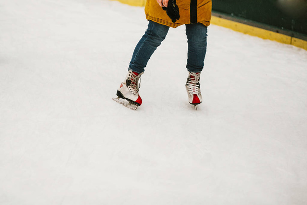 Bruslaři Bruslení na Eva kroužek v Evropském centru v zimních svátků. Děti hrají na bílé ledové Frištenský, zdravé činnosti. Dětské nohy v bruslích - Fotografie, Obrázek