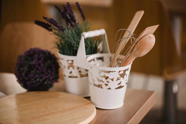 Kitchen accessories in the style of Provence. Devices for cooking from natural wood. Lavender in a pot. Background for food concept design or interior design. - 写真・画像