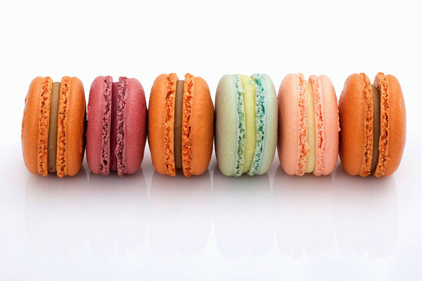 lot of colorful macarons on white background closeup view - Photo, Image