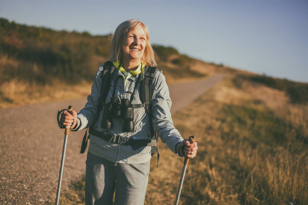 Senior woman is hiking in mountain. Active retirement. - Valokuva, kuva