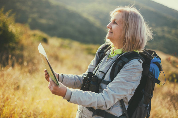 Senior woman is hiking in mountain. Active retirement. - Фото, зображення