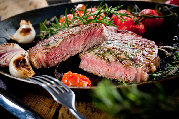 Grilled Black Angus Steak Striploin on frying cast iron Grill pan on dark background - Photo, Image