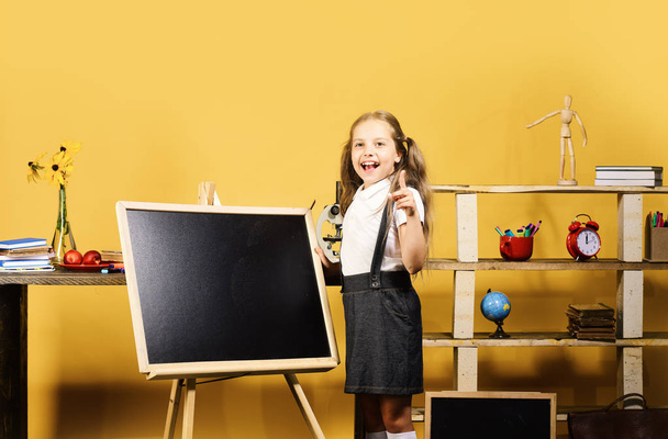 Kid and school supplies on yellow background - Фото, зображення
